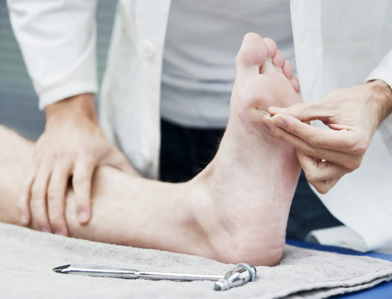 A healthcare professional conducting a sensory test on a patient's foot using a monofilament, assessing for signs of neuropathy.