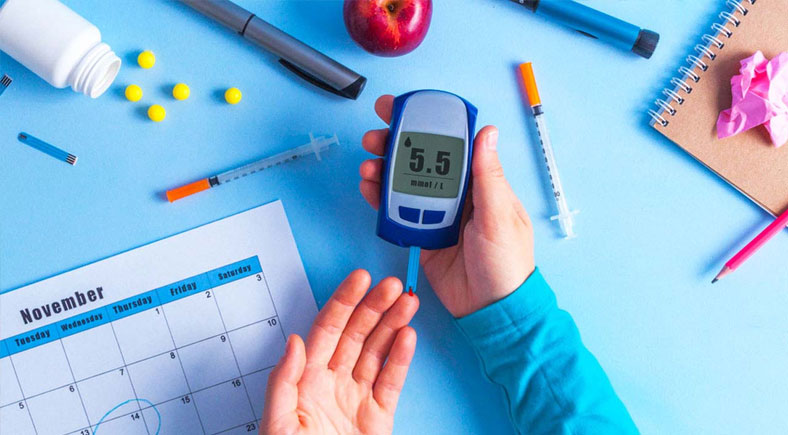 Diabetes management tools, including a glucose meter, syringes, and medication, used for health monitoring.