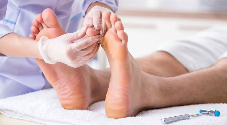 Healthcare professional inspecting diabetic patient's feet for ulcers and signs of infection as part of daily foot care routine to prevent diabetic foot ulcers.