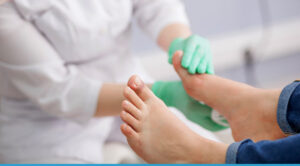 Healthcare professional examining a patient's foot for diabetic foot ulcer management.