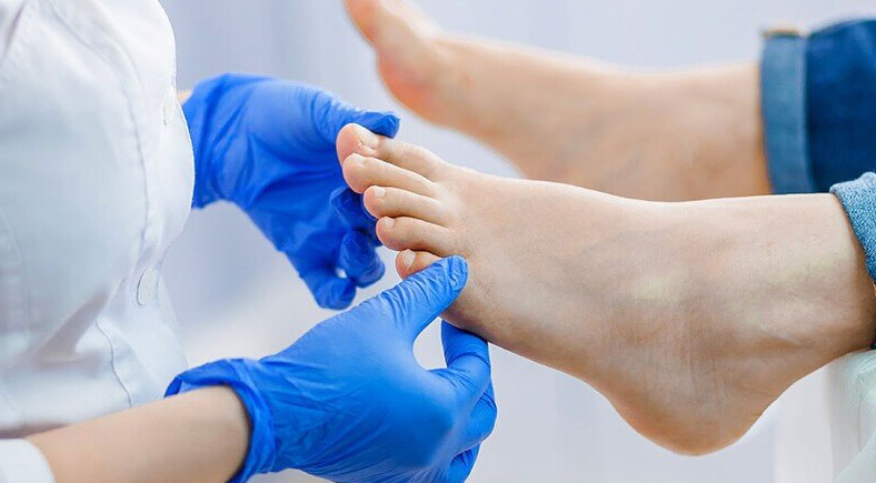 A healthcare professional performing a foot health assessment at Foot & Wound Institute.