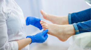 Medical professional performing a foot health checkup on a patient, emphasizing preventive care for foot conditions.